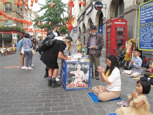 '图7：二零二零年八月十六日，三位意大利青年在伦敦唐人街签名支持法轮功反迫害'