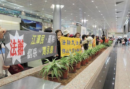 '中共海协会长陈德铭来台，法轮功学员在机场举横幅反迫害。'