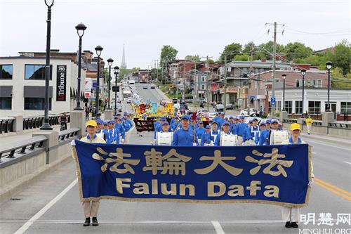 '图1：2021年5月30日，法轮功学员在加拿大魁北克省舍布鲁克市（Sherbrooke）举行游行活动，庆祝世界法轮大法日暨法轮大法（法轮功）弘传世界29周年。'