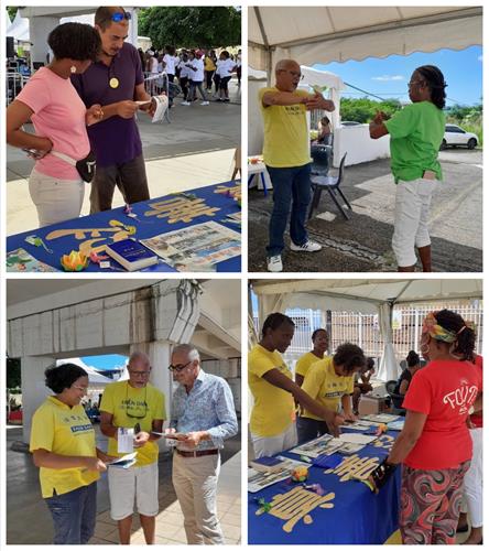 图1：二零二二年十月十四日至二十三日，加勒比海的法轮功学员在瓜德路普举办的“精神健康周”上，向人们介绍法轮功及其真相。有民众现场学功。